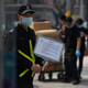 A security guard holds a sign advising that photos are forbidden without permission, outside a store of Swedish clothing giant H&M in Beijing on March 25, 2021,